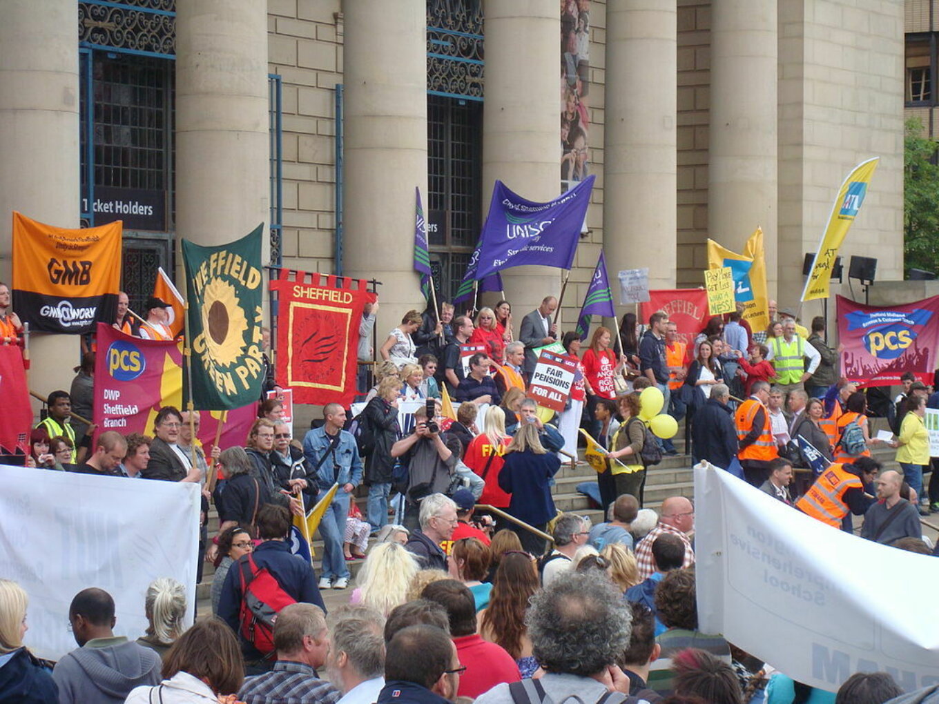 Lots of people and banners on the steps of Sheffield City Hall