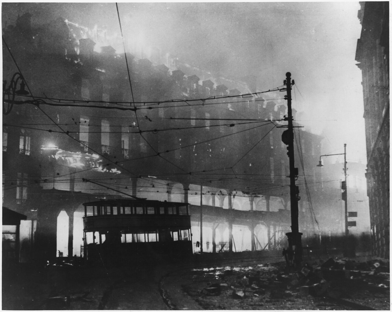 A black and white photo of a burning building.