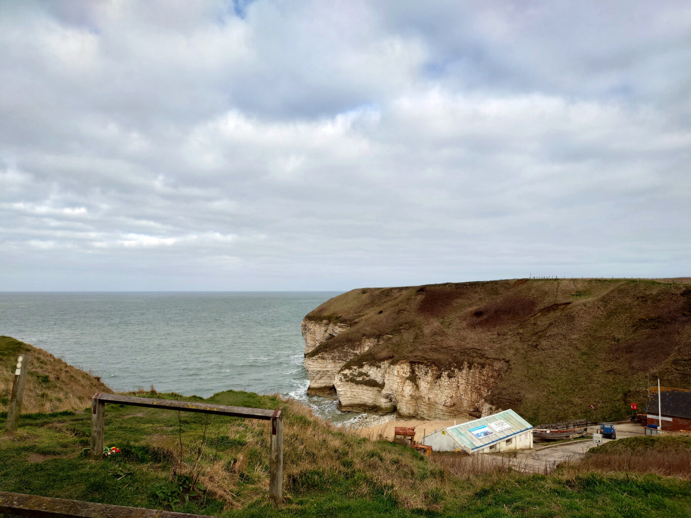 Dramatic cliffs with the sea and a cloudy sky