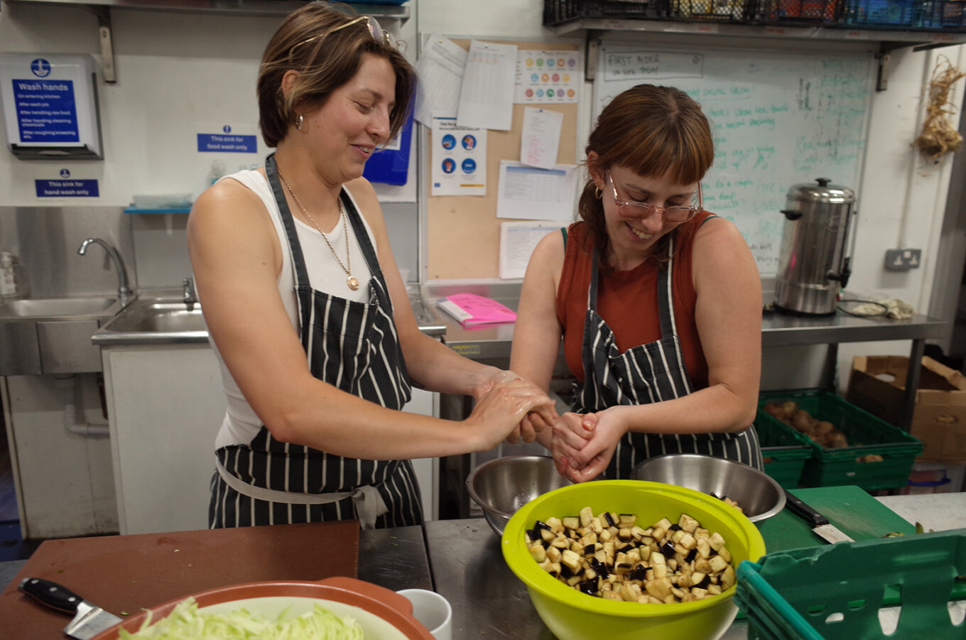 Two women making pickle at a Glut Club event organised by Social Pickle.