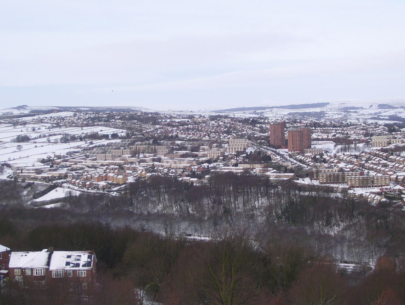 A view of distant houses with a coating of snow
