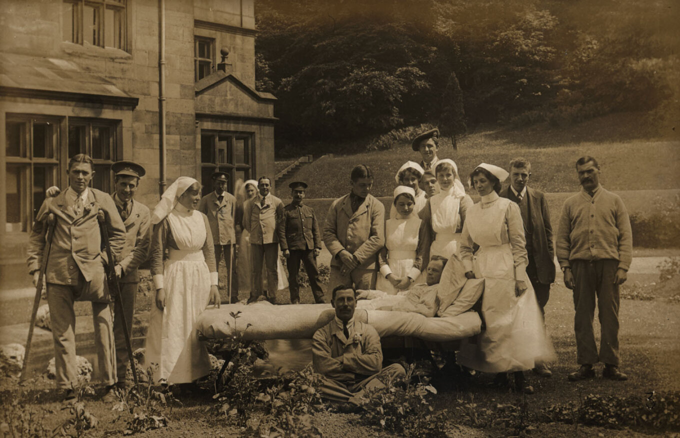 A black and white photograph of nurses and injured soldiers.