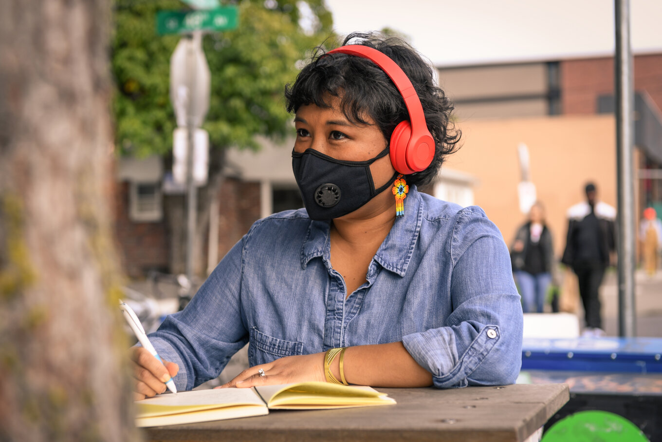 A person wearing a face mask and headphones
