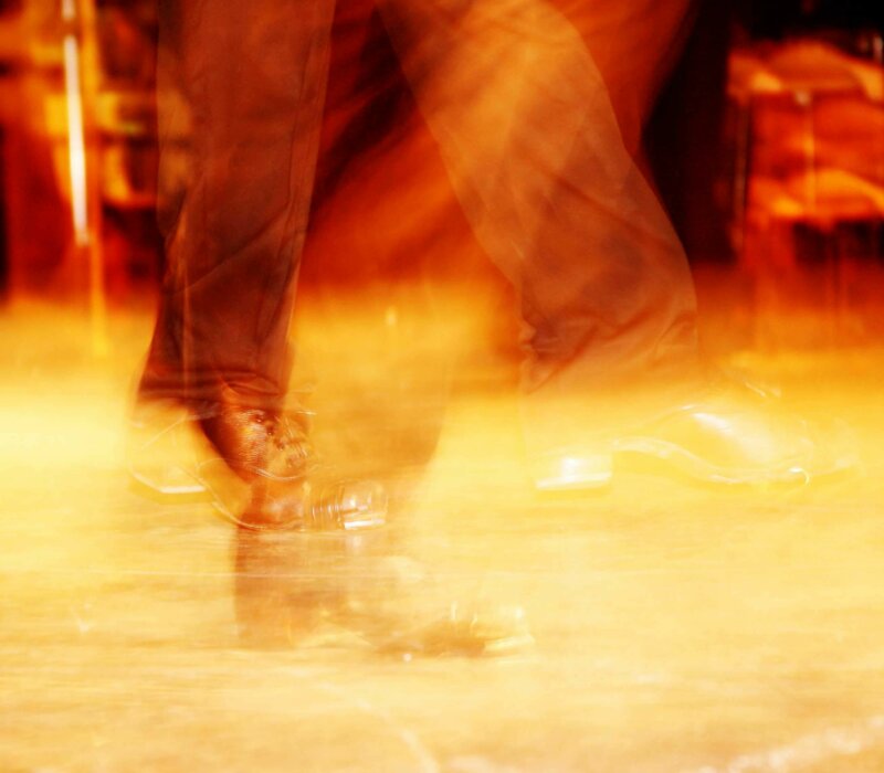 Feet moving on a dancefloor